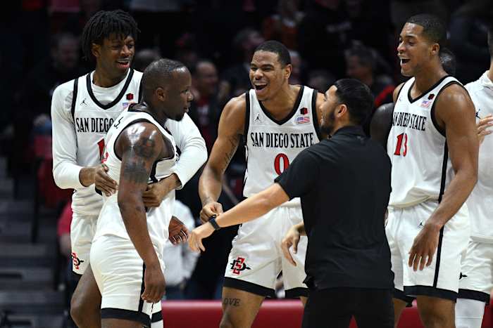 an Diego, California, USA; San Diego State Aztecs guard Adam Seiko (2) is congratulated after a three-point basket during the first half against the Utah State Aggies at Viejas Arena.