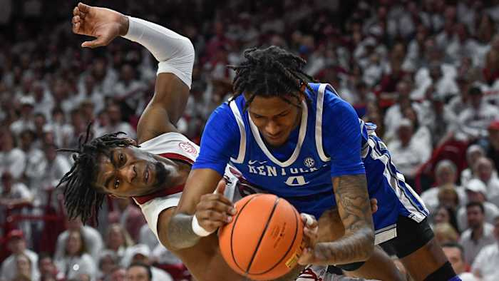 Arkansas Razorbacks Kamani Johnson tries to get the ball from Kentucky Wildcats Daimion Collins.