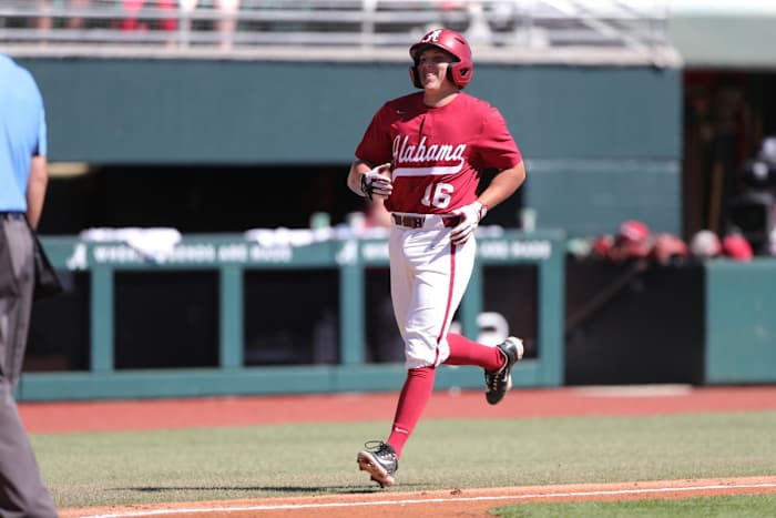 Alabama third baseman Colby Shelton (16) crosses home plate with a smile after hitting a grand slam against the UIC Flames on March 5, 2023 at Sewell-Thomas Stadium in Tuscaloosa, Ala.