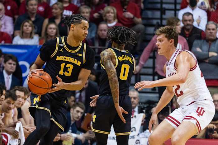 Michigan Wolverines guard Jett Howard (13) dribbles the ball while Indiana Hoosiers forward Miller Kopp (12) defends.