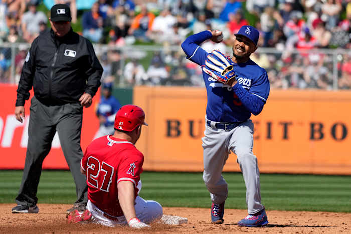 Dodgers second baseman Mookie Betts throws to first base after forcing out Los Angeles Angels’ Mike Trout