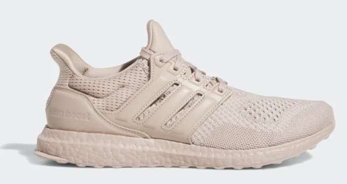 Side view of a tan adidas shoe.