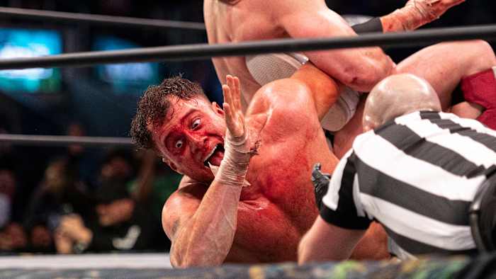 Bryan Danielson puts a bloodied MJF in a submission hold
