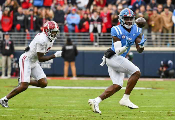 Nov 12, 2022; Oxford, Mississippi, USA; Ole Miss wide receiver Jonathan Mingo (1) catches a pass with Alabama defensive back DeMarcco Hellams (2) covering at Vaught-Hemingway Stadium. Mandatory Credit: Gary Cosby Jr.-USA TODAY Sports