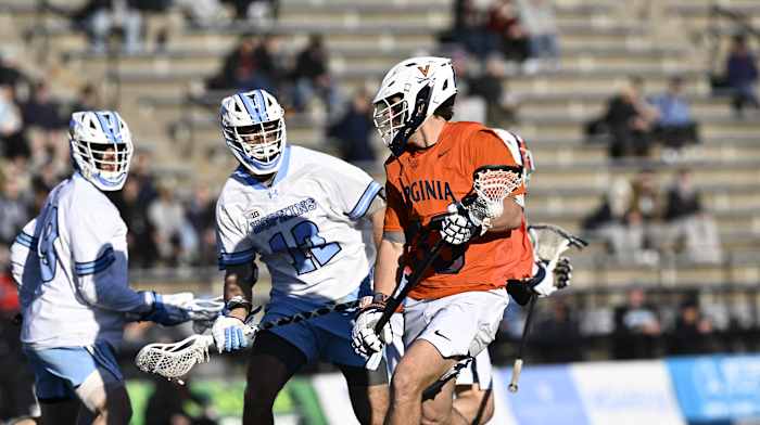 Peter Garno dodges with the ball during the Virginia men's lacrosse against Johns Hopkins at Homewood Field in Baltimore, Maryland.