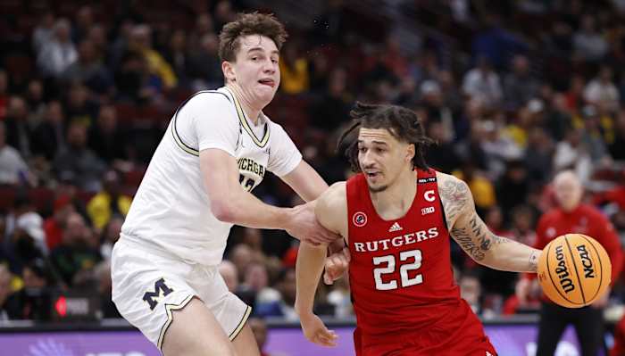Rutgers guard Caleb McConnell (22) drives to the basket against Michigan forward Will Tschetter (42) during the first half. (Kamil Krzaczynski-USA TODAY Sports)