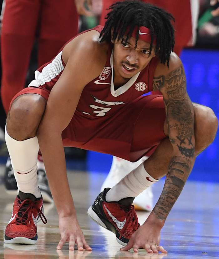 Arkansas Razorbacks Nick Smith squats down late in the SEC Tournament against the Auburn Tigers.