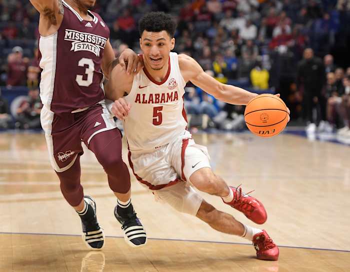 Alabama Crimson Tide guard Jahvon Quinerly (5) drives past Mississippi State Bulldogs guard Shakeel Moore (3) during the second half at Bridgestone Arena.