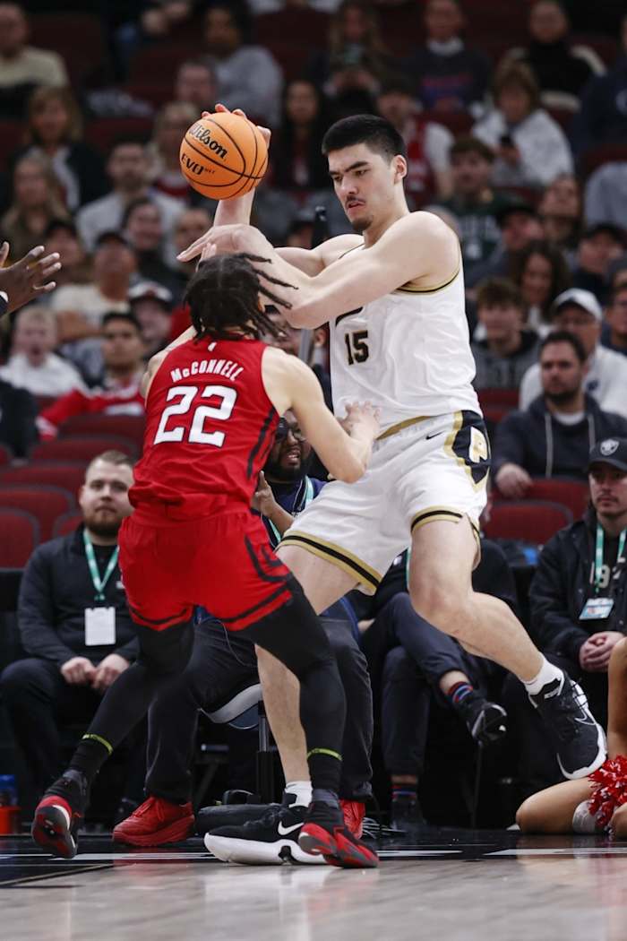 Rutgers Scarlet Knights guard Caleb McConnell (22) defends against Purdue Boilermakers center Zach Edey (15) during the first half at United Center.