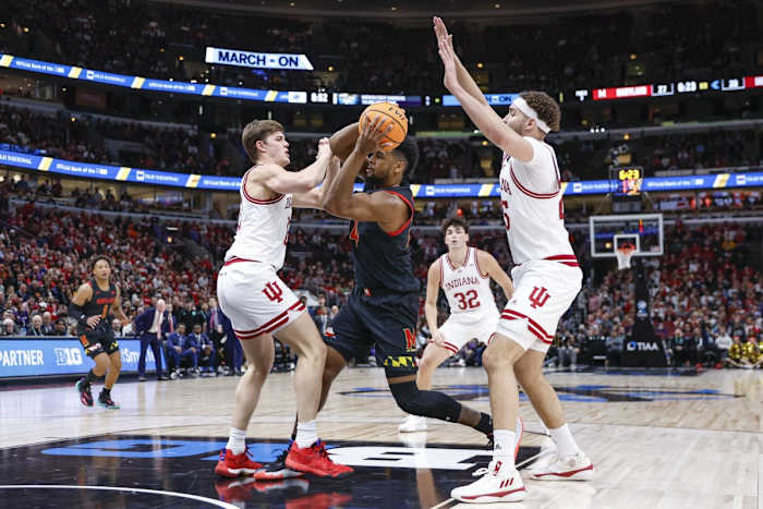 Maryland's Donta Scott (24) drives to the basket against the Indiana's Miller Kopp (12) and Race Thompson (25) during the first half at United Center.