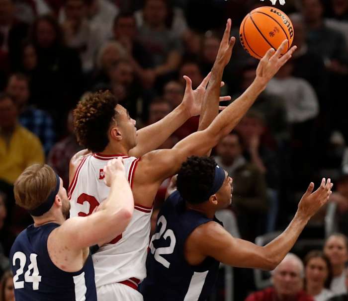 Nittany Lions forward Michael Henn (24), Hoosiers forward Trayce Jackson-Davis (23) and Nittany Lions guard Jalen Pickett (22) fight for a rebound.
