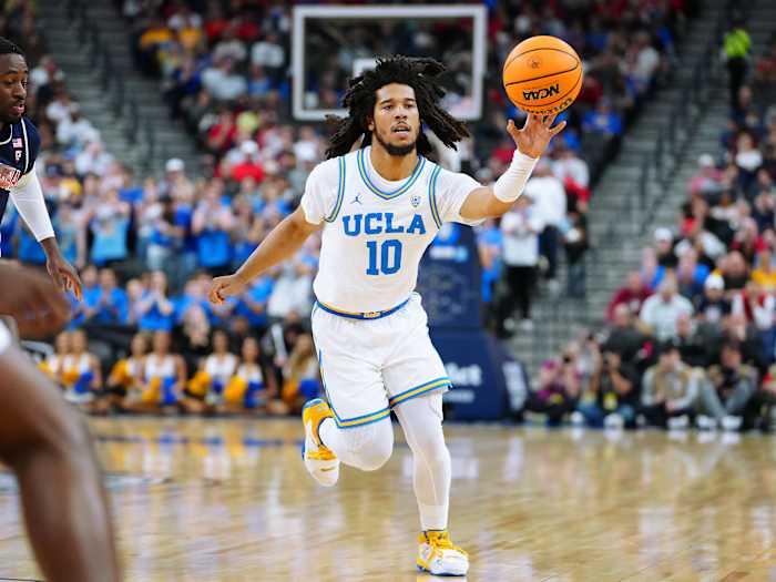UCLA Bruins guard Tyger Campbell passes the ball.