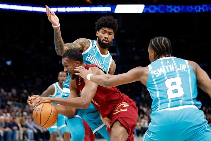 Mar 12, 2023; Charlotte, North Carolina, USA; Cleveland Cavaliers forward Evan Mobley (4) drives through Charlotte Hornets guard Dennis Smith Jr. (8) and center Nick Richards (4) during the first half at Spectrum Center. Mandatory Credit: Brian Westerholt-USA TODAY Sports