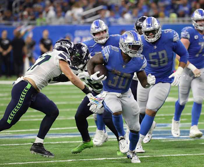 Detroit Lions running back Jamaal Williams runs past Seattle Seahawks defenders. 