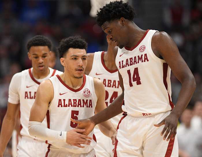 Alabama Crimson Tide guard Jahvon Quinerly (5) and center Charles Bediako (14) celebrate the win against the Texas A&M Aggies during the second half at Bridgestone Arena.