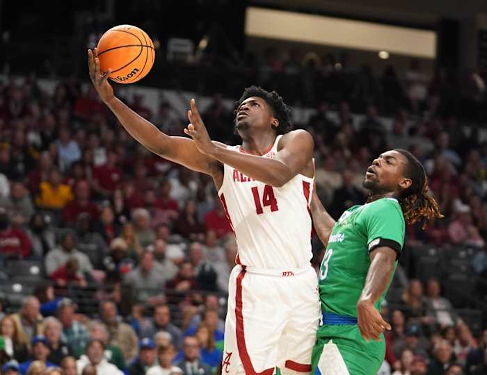 Mar 16, 2023; Birmingham, AL, USA; Alabama Crimson Tide center Charles Bediako (14) shoots against Texas A&M-CC Islanders forward De'Lazarus Keys (13) during the first half in the first round of the 2023 NCAA Tournament at Legacy Arena. Mandatory Credit: Marvin Gentry-USA TODAY Sports