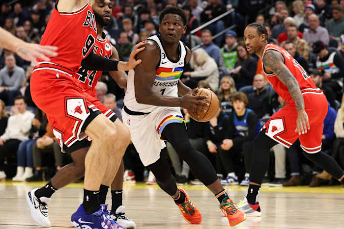 Dec 18, 2022; Minneapolis, Minnesota, USA; Minnesota Timberwolves guard Anthony Edwards (1) dribbles while Chicago Bulls center Nikola Vucevic (9) defends