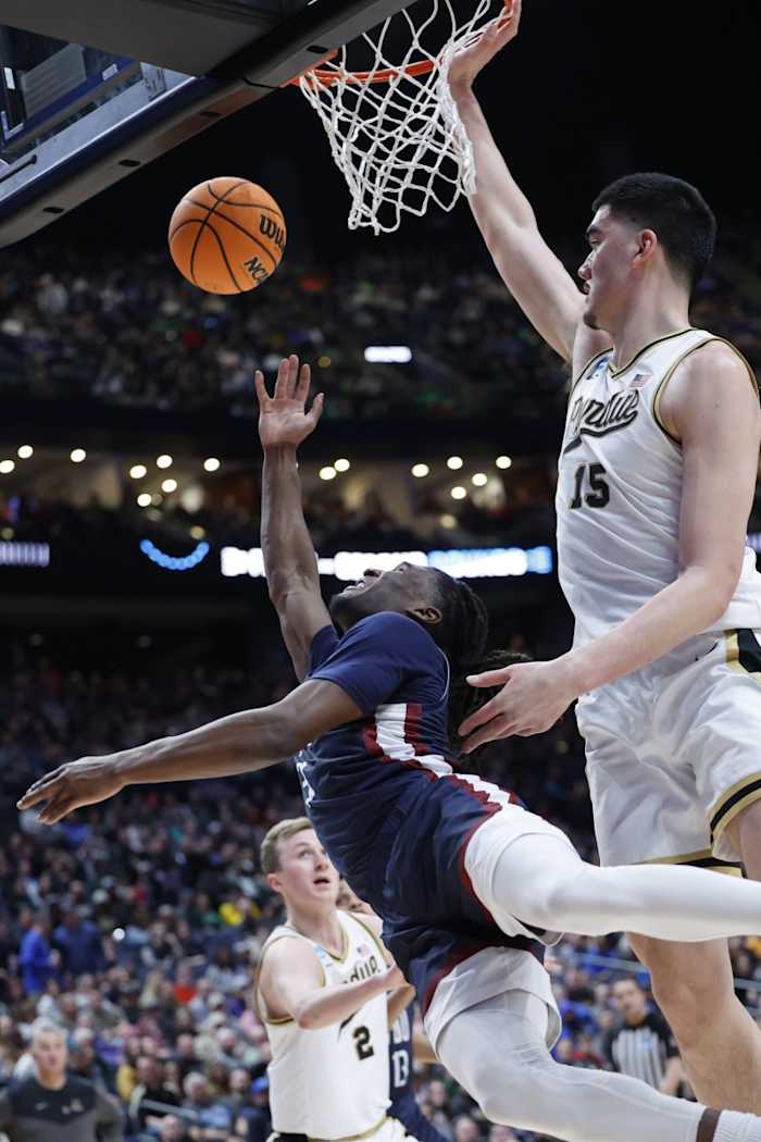 Knights guard Heru Bligen (3) shoots the ball defended by Purdue Boilermakers center Zach Edey (15).