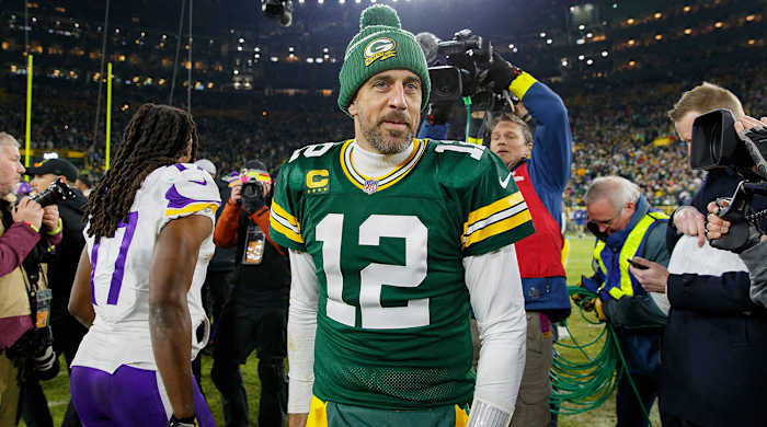 Aaron Rodgers walks around the field after a game against the Vikings.