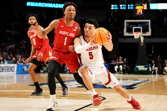 Mar 18, 2023; Birmingham, AL, USA; Alabama Crimson Tide guard Jahvon Quinerly (5) drives against Maryland Terrapins guard Jahmir Young (1) during the first half at Legacy Arena.