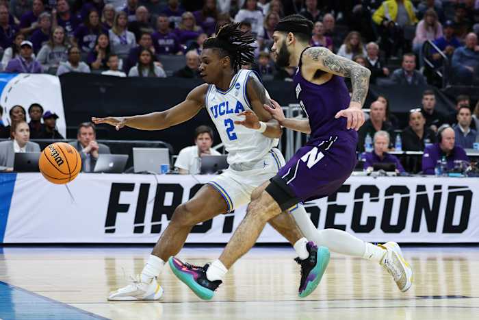 UCLA Bruins guard Dylan Andrews dribbles past Northwestern Wildcats guard Boo Buie.