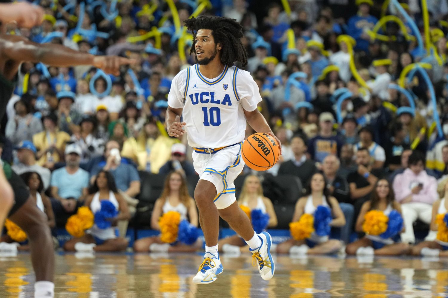 UCLA Bruins guard Tyger Campbell dribbles the ball up the floor.