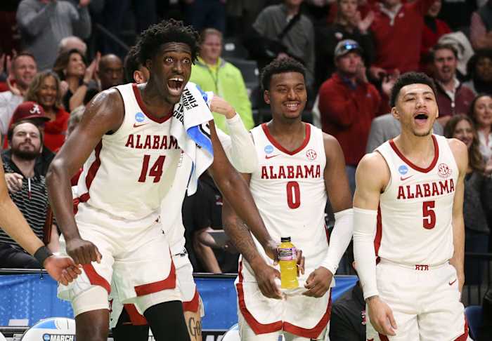 Mar 18, 2023; Birmingham, AL, USA; Alabama center Charles Bediako (14) reacts to a basket by substitute Alabama guard Delaney Heard (12) at Legacy Arena during the second round of the NCAA Tournament. Alabama advanced to the Sweet Sixteen with a 73-51 win over Maryland.