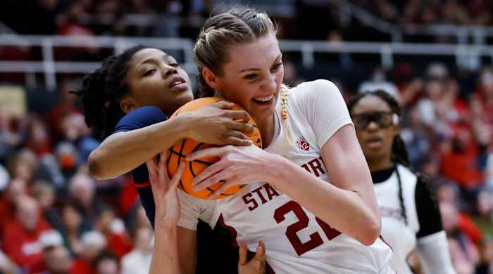 Mississippi guard Angel Baker and Stanford forward Cameron Brink vie for the ball in the second round of the NCAA women’s tournament.
