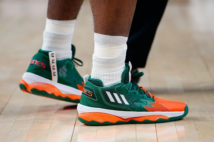 View of green and orange adidas shoes.