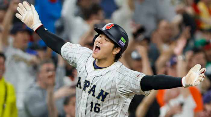 Team Japan DH Shohei Ohtani celebrates with his arms wide while rounding the bases after scoring on a teammate’s three-run homer during the WBC semifinals against Mexico