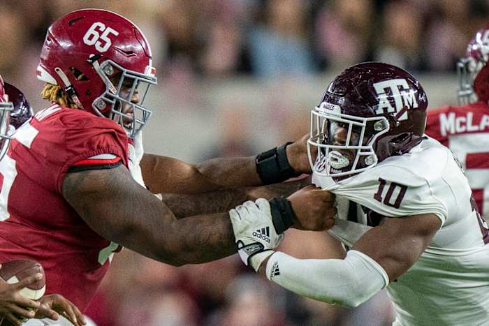 Oct 8, 2022; Tuscaloosa, Alabama, USA; Alabama Crimson Tide offensive lineman JC Latham (65) blocks Texas A&M Aggies defensive lineman Fadil Diggs (10) during the second half at Bryant-Denny Stadium.
