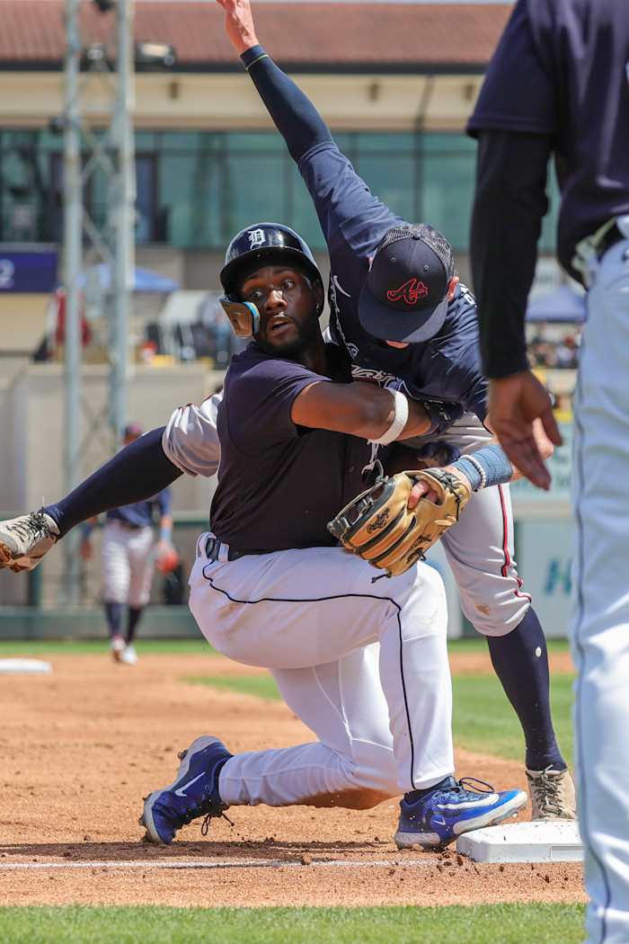 Mar 22, 2023; Lakeland, Florida, USA; Detroit Tigers left fielder Akil Baddoo (60) slides safely into third base in front of Atlanta Braves third baseman Mitchell Tolman (81) during the second inning at Publix Field at Joker Marchant Stadium. Mandatory Credit: Mike Watters-USA TODAY Sports