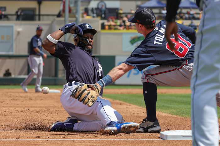 Mar 22, 2023; Lakeland, Florida, USA; Detroit Tigers left fielder Akil Baddoo (60) slides safely into third base in front of Atlanta Braves third baseman Mitchell Tolman (81) during the second inning at Publix Field at Joker Marchant Stadium. Mandatory Credit: Mike Watters-USA TODAY Sports