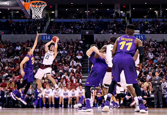 Mar 20, 2016; Oklahoma City, OK, USA; Texas A&M Aggies guard Alex Caruso (21) shoots against Northern Iowa Panthers guard Wyatt Lohaus (33) in the first half during the second round of the 2016 NCAA Tournament at Chesapeake Energy Arena.