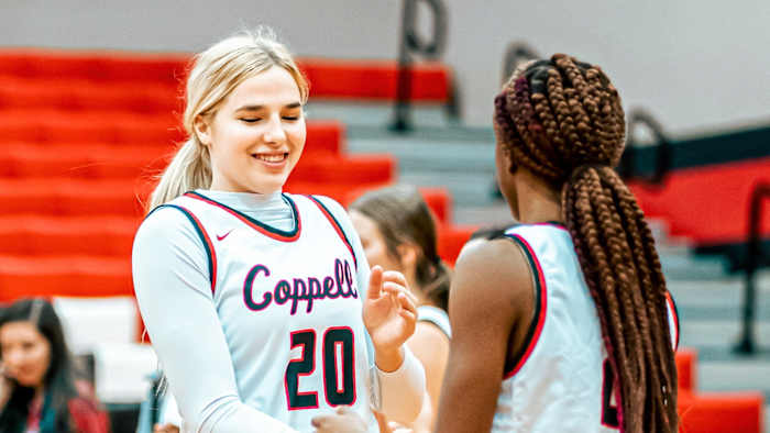 Julianna LaMendola greets her teammate during a Coppell High School basketball game.