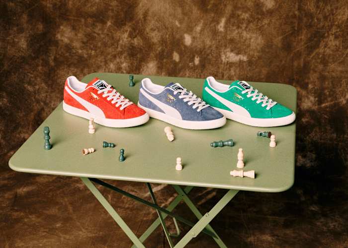View of red, blue, and green Puma shoes on a table.