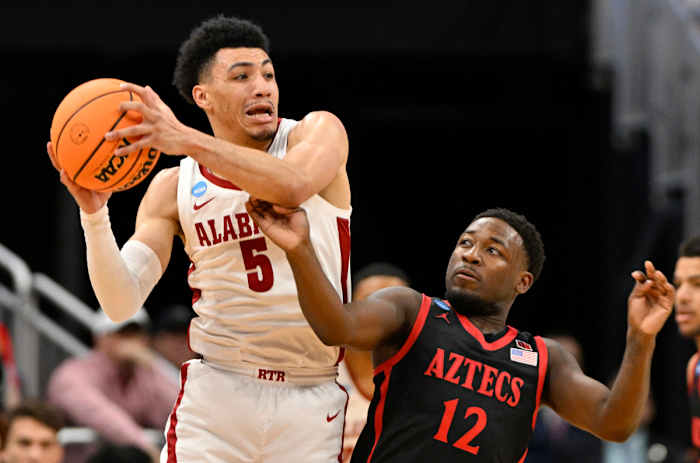 Mar 24, 2023; Louisville, KY, USA; Alabama Crimson Tide guard Jahvon Quinerly (5) looks to pass against San Diego State Aztecs guard Darrion Trammell (12) during the first half of the NCAA tournament round of sixteen at KFC YUM! Center. Mandatory Credit: Jamie Rhodes-USA TODAY Sports