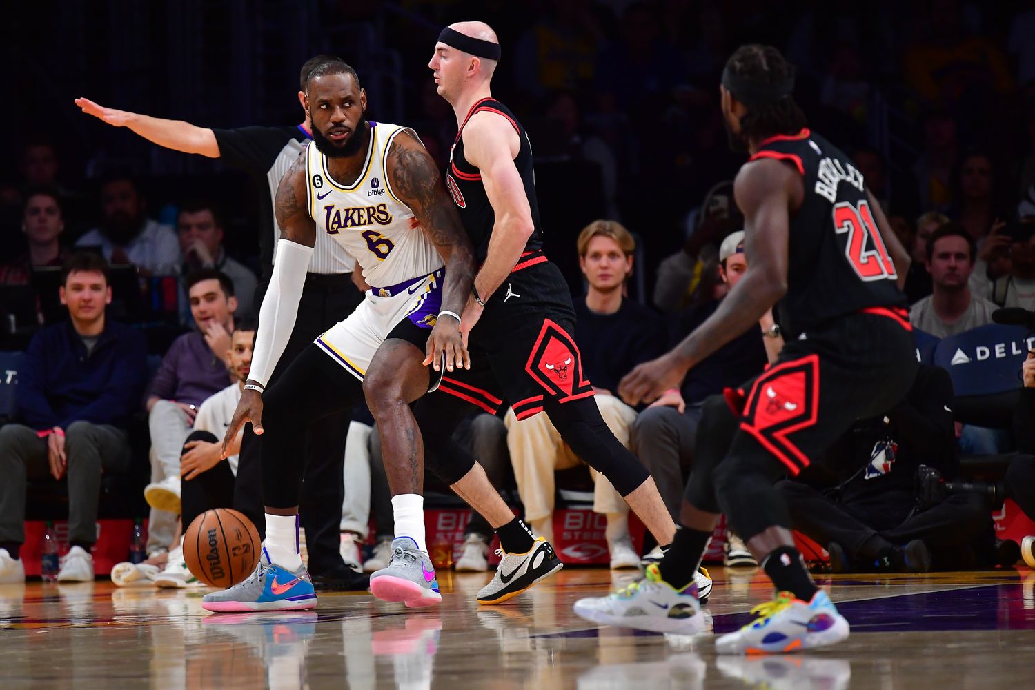 Chicago Bulls guard Alex Caruso defends Los Angeles Lakers forward LeBron James.