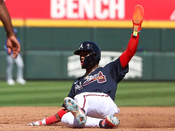 Feb 27, 2023; North Port, Florida, USA; Atlanta Braves right fielder Ronald Acuna Jr. (13) slides into third against the Toronto Blue Jays in the second inning during spring training at CoolToday Park.