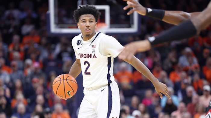 Reece Beekman dribbles the ball during the Virginia men's basketball game against Louisville at John Paul Jones Arena.