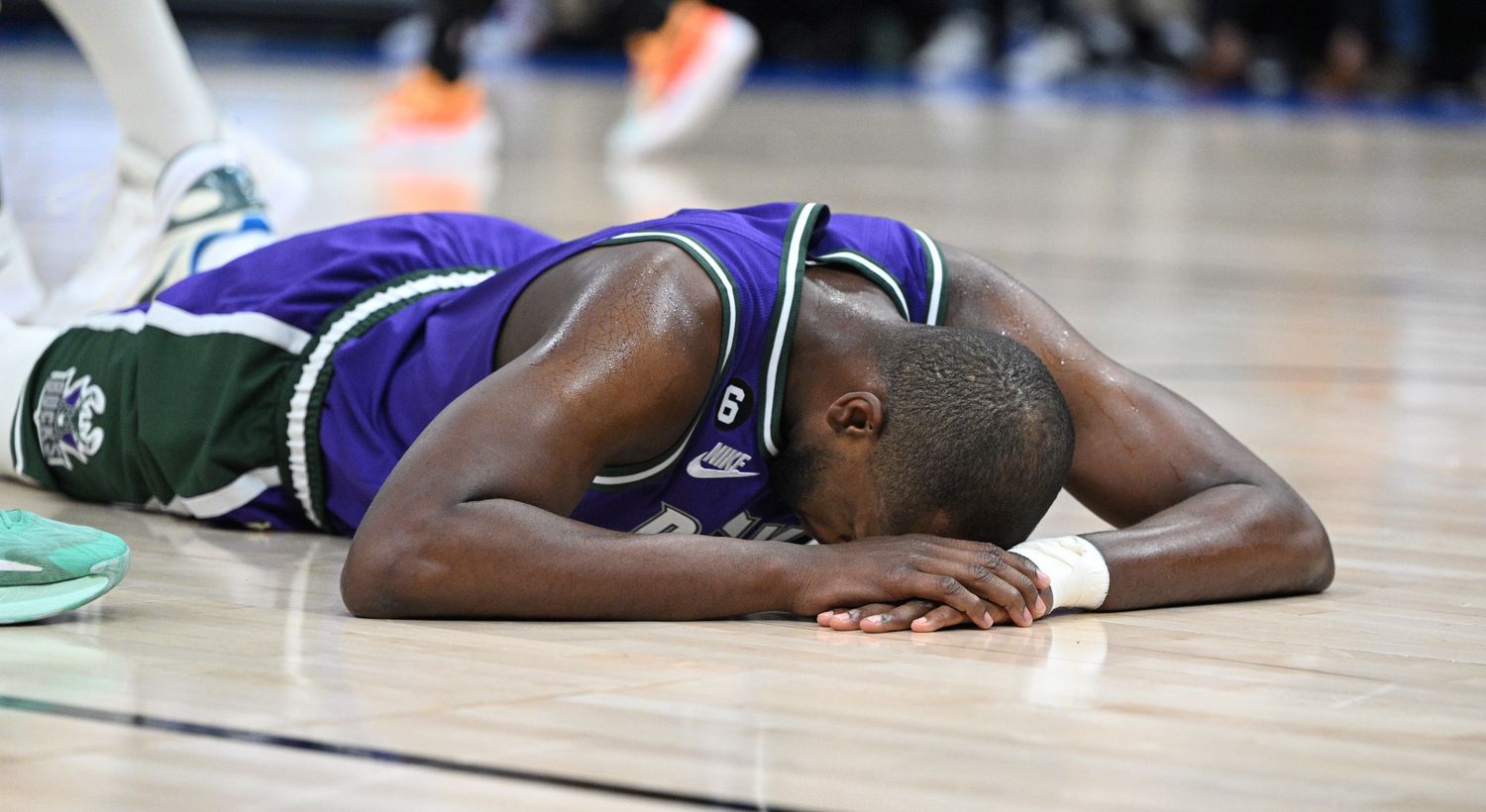 Mar 30, 2023; Milwaukee, Wisconsin, USA; Milwaukee Bucks forward Khris Middleton (22) goes down after a collision with a Boston Celtics player in the second half causing him to sit out the rest of the game at Fiserv Forum.