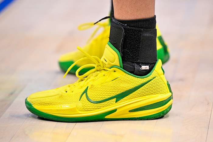 View of yellow and green Nike shoes.