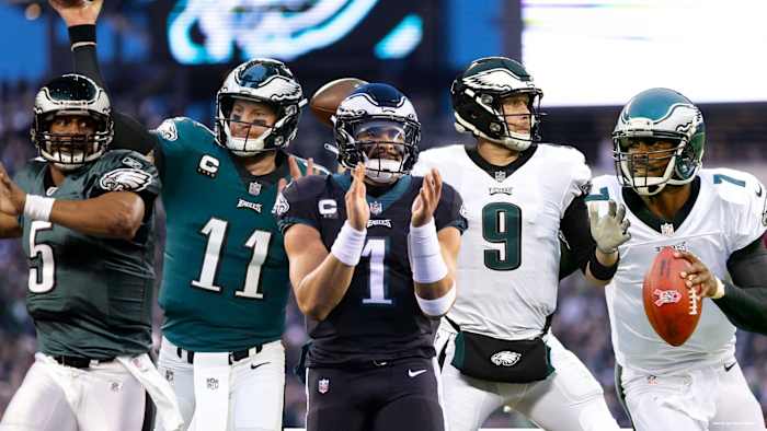 Philadelphia Eagles quarterbacks (from left to right) Donovan McNabb (5), Carson Wentz (11), Jalen Hurts (1), Nick Foles (9), and Michael Vick (7).