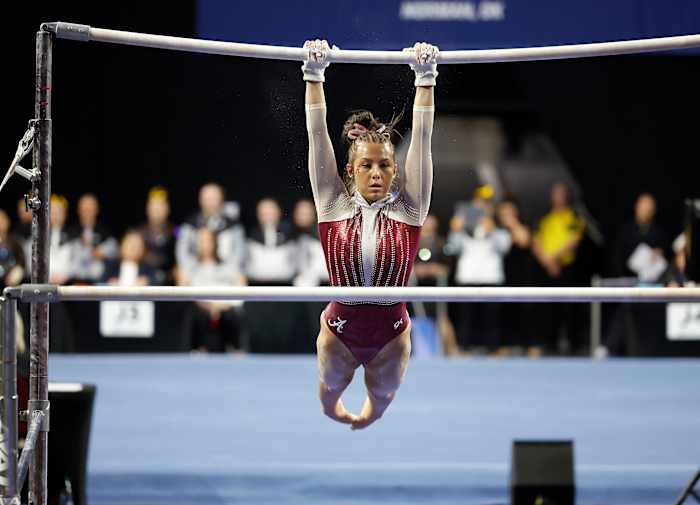 University of Alabama gymnast Cam Machado performs bars exercise during the 2023 NCAA women's gymnastics regional at Lloyd Noble Center.