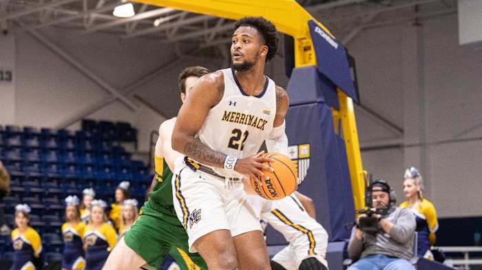 Merrimack forward Jordan Minor looks to pass against Vermont.