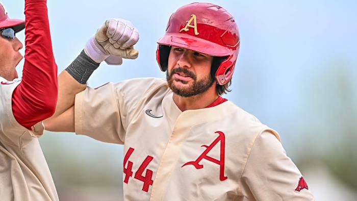 Razorbacks catcher Parker Rowland with first base coach Bobby Wernes after an RBI single in the sixth inning against Alabama.
