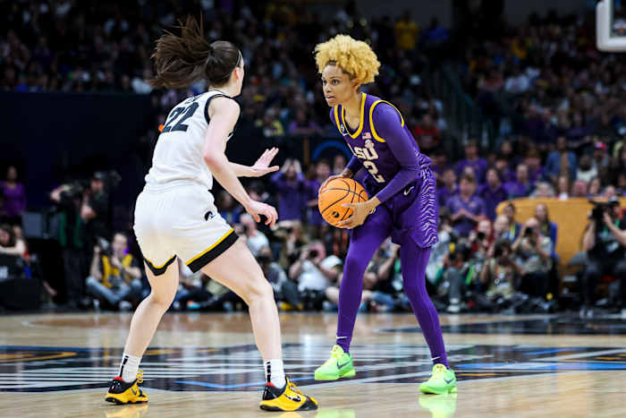 Iowa Hawkeyes guard Caitlin Clark defends LSU Tigers guard Jasmine Carson.
