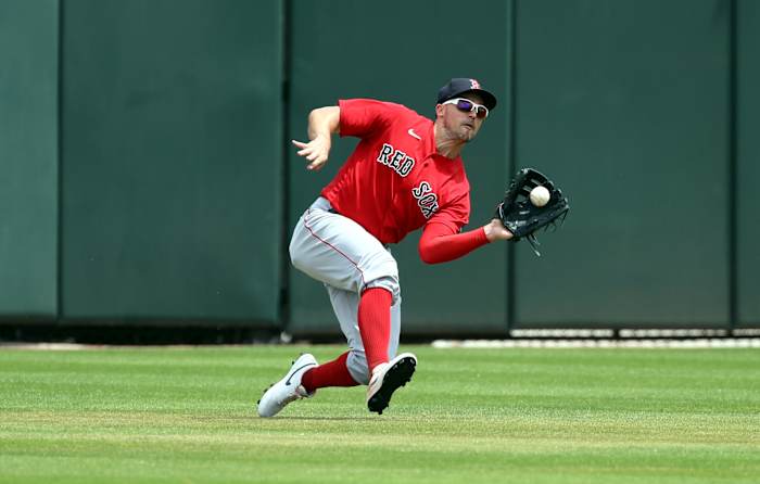 Boston Red Sox center fielder Adam Duvall catches a fly ball against Atlanta. (2023)