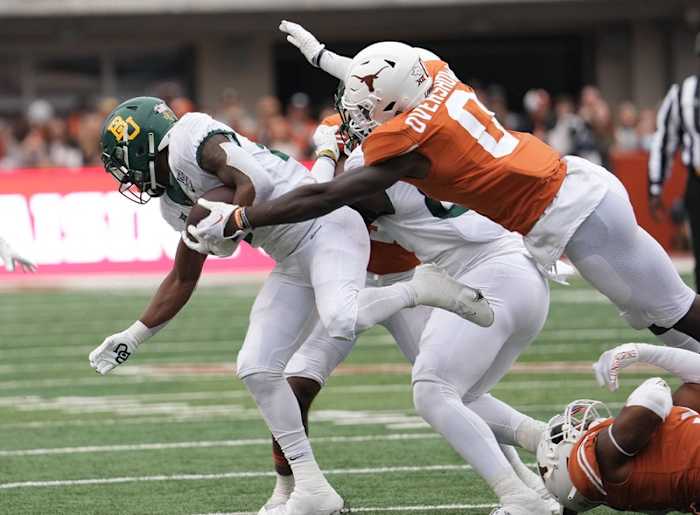 Texas Longhorns linebacker DeMarvion Overshown (0) takes down Baylor Bears running back Richard Reese (29) during the Texas Longhorns game against Baylor on Friday, Nov. 25, 2022. Ut Baylor Football 02373