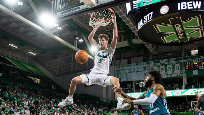 Marshall forward Micah Handlogten dunks the ball against Coastal Carolina.